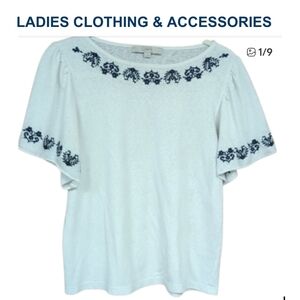 Shirt. Loft. Floral detail around neck and sleeves.Pit To Pit 19. Length 22 In.